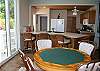 Next to the pool, a slider leads into the lower livng level. The full kitchen is great for poolside snacks, and the nearby poker table (with cards and chips provided) converts to a bumper pool table for lots of fun away from the sun!