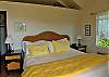 The air conditioning that's provided is rarely needed in this airy bedroom suite. Door curtains on swing rods filter light when you want it. A king sized bed and large bathroom complete the picture.