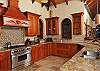 Additional amenities include: a 6 – burner stainless steel professional Blue Star range-  as featured in The Next Iron Chef, KitchenAid refrigerator, dishwasher, microwave and custom mahogany cabinetry with hand carved details.