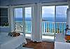 This poolside bedroom on the first floor faces sliding doors and windows providing through breezes. The bed is positioned to take advantage of the gorgeous views of Rendezvous Bay!