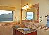 Each insuite bathroom has a glass block and tile shower with rain showerhead a marble top vanity and sweet views.