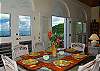 Indoor dining comfortably seats six. Just steps away you can dine under the stars around a teak dining room set on the spacious veranda.