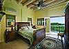 This air-conditioned bedroom boasts high ceilings, oriental carpets, a queen sized sleigh bed, warm relaxing colors and mountain views.