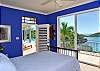 Colorful bedrooms, complete with huge glass windows and doors seem to bring the outside in.