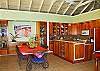 The full kitchen assures everything within reach and is perfect for simple meals to elegant dining. The dining table comfortable seats up to six guests . Colorful artwork frames one wall and your backdrop is the azure ocean below.