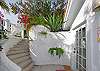 Your entryway to the third bedroom in the guest cottage is colorful and bright with tropical plants.