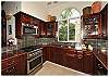 The kitchen features stainless steel appliances, granite countertops and rich mahogany cabinetry-all these amenities and more will delight even the most skillful artesian.