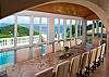With perhaps what can be classified as one of the largest indoor dining table on-island, the huge 16 person dining table was crafted by David Rairick, creator of Aurastone and sits amidst a wall of windows allowing guests to dine amidst some o the best views on St. John