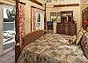 This spacious air-conditioned bedroom has it's own canopy bed, television and in suite bathroom with shower. The bedroom boasts high ceilings, oriental carpets, warm soothing colors and mountain and ocean views. Its private deck has vistas of Hart Bay...and beyond!