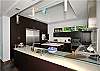 A gourmet kitchen equipped with stemware and kitchen tools to suit the most discerning culinary artist.