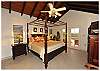 The master bedroom features a 4-poster king bed and glorious views of the bay below.
