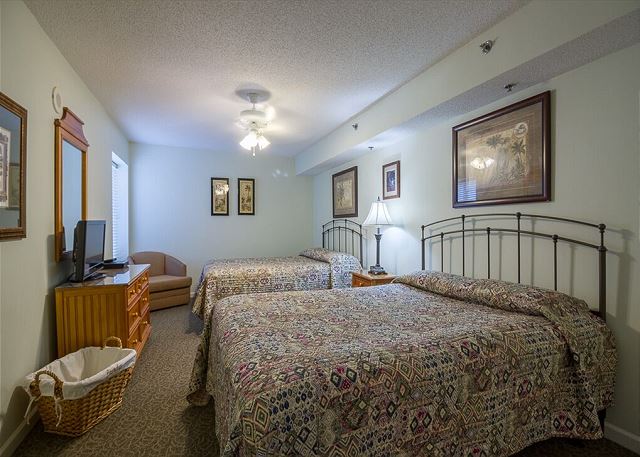 -2 queen size beds, 26'" flat screen TV and DVD player, ceiling fan, a full length dresser with mirror, night stand, lamp, alarm clock, phone and a nice sized closet with hangers.