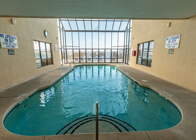 Resort features include an indoor pool with a glass wall and high ceilings to make the the pool & deck feel open and grand even on a rainy day.