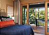 Bedroom #1 with ocean views and sliding doors to the lanai