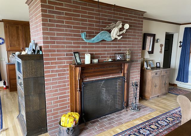 Image Wood fireplace with a fire log supplied.