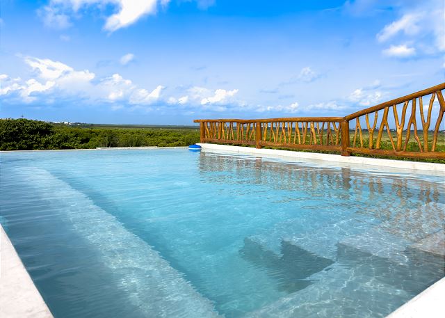 Gorgeous, shared, infinity pool on the roof.  Looking toward the lush mangrove forest.