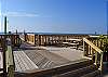 Deck and boardwalk to beach - picnic tables, grills, and beach shower.