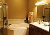 The master bathroom has a Jacuzzi tub, stand alone tile shower, double bowl sink and a private commode area.
