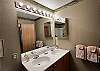 The private en suite bathroom has a double vanity, toilet, and large shower/jetted tub combo.