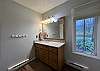 This full bathroom is located on the upper floor of the townhouse and is shared among the three bedrooms.