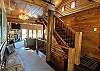 As you walk in through the front door entrance, you'll be greeted by the beautiful wood work of this authentic log home.