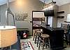 The loft area has a TV, bar, pac man machine and an old 7 Springs chair lift as seating!