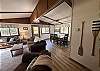 Open living and dining space at Liam's Landing, with paddles hung on the wall between them.