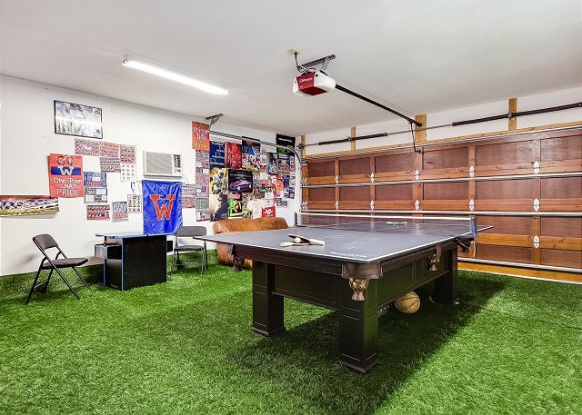 Enjoy this turfed game room with darts, billiards, ping pong, and other games!