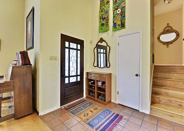 Front entry way leading to the main sitting, main living, and kitchen area