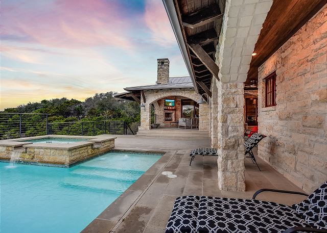 The pool, hot tub, and chairs to enjoy the area