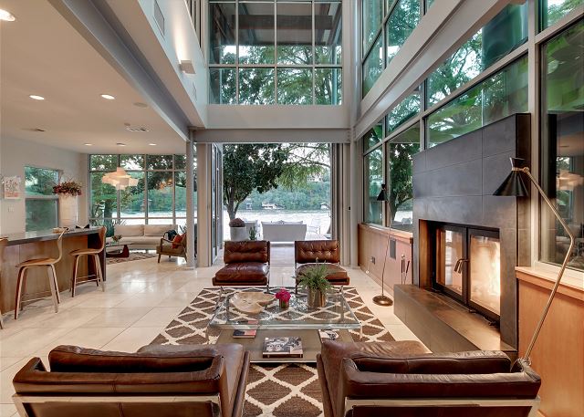 Spacious living room with large glass sliding doors that fully open creating a beautiful indoor/outdoor living area