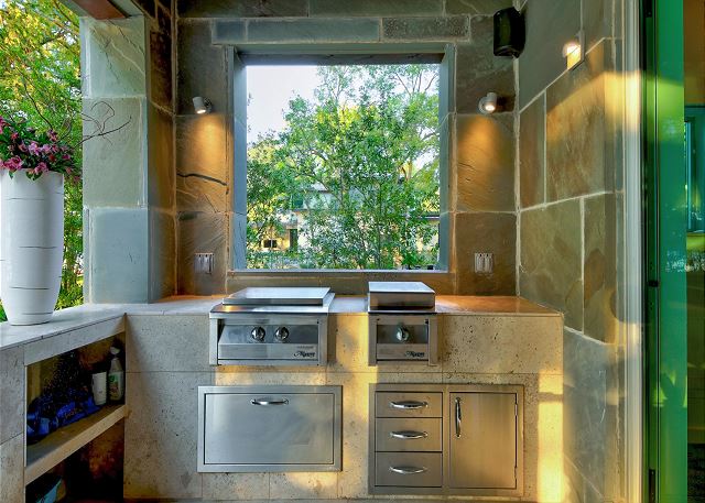 Cook up a delicious meal in this outdoor kitchen with high end appliances