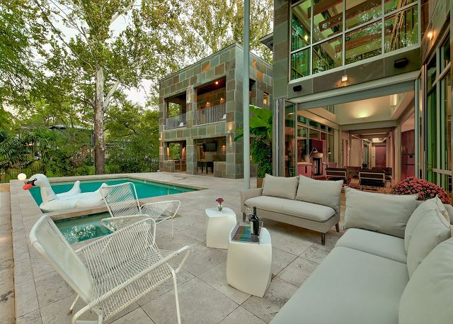 Relax by the pool while friends and family play a round of pool volleyball