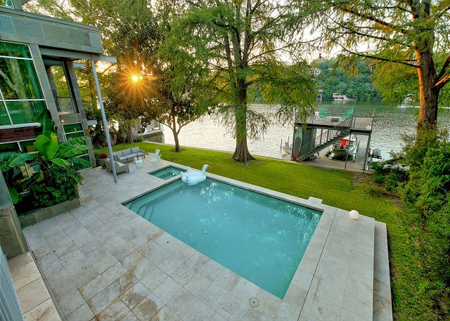 Spacious outdoor area with large pool, hot tub, and lawn space perfect for family reunions