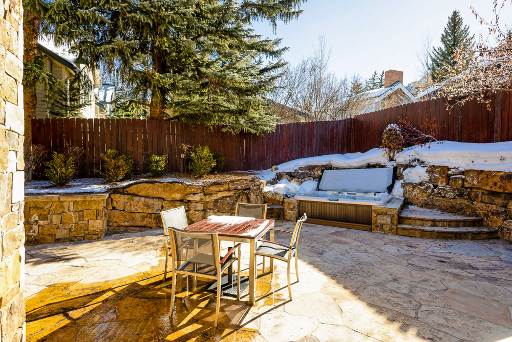 Outdoor seating and hot tub. 