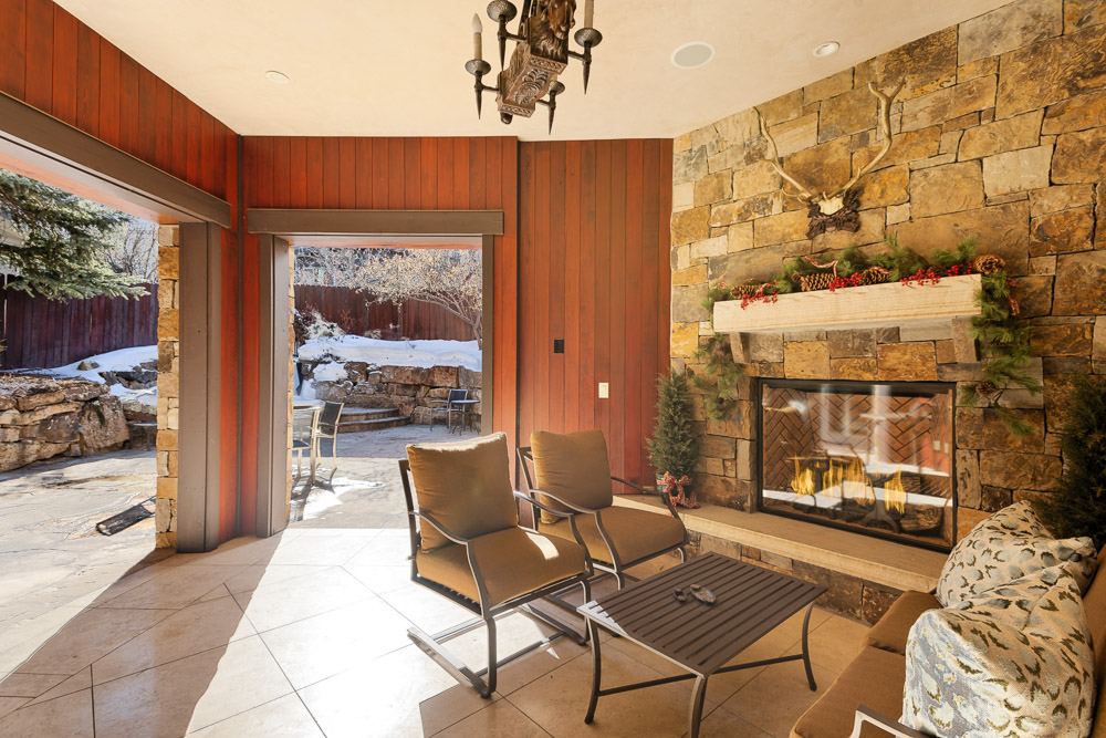 Outdoor covered seating area with fireplace. 