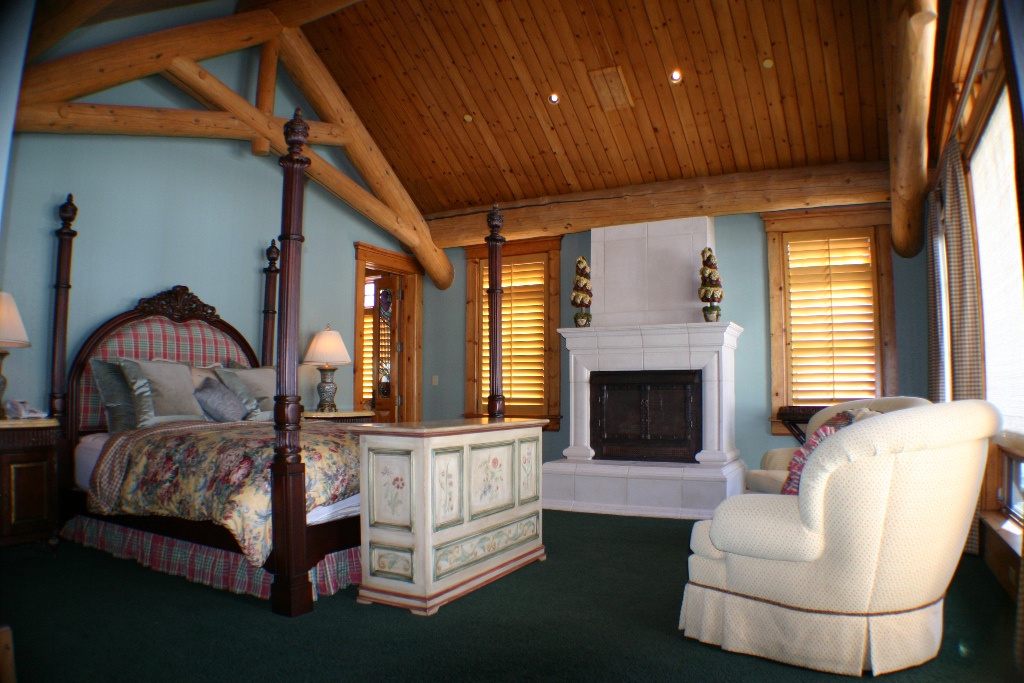 Master suite with fireplace and seating. 