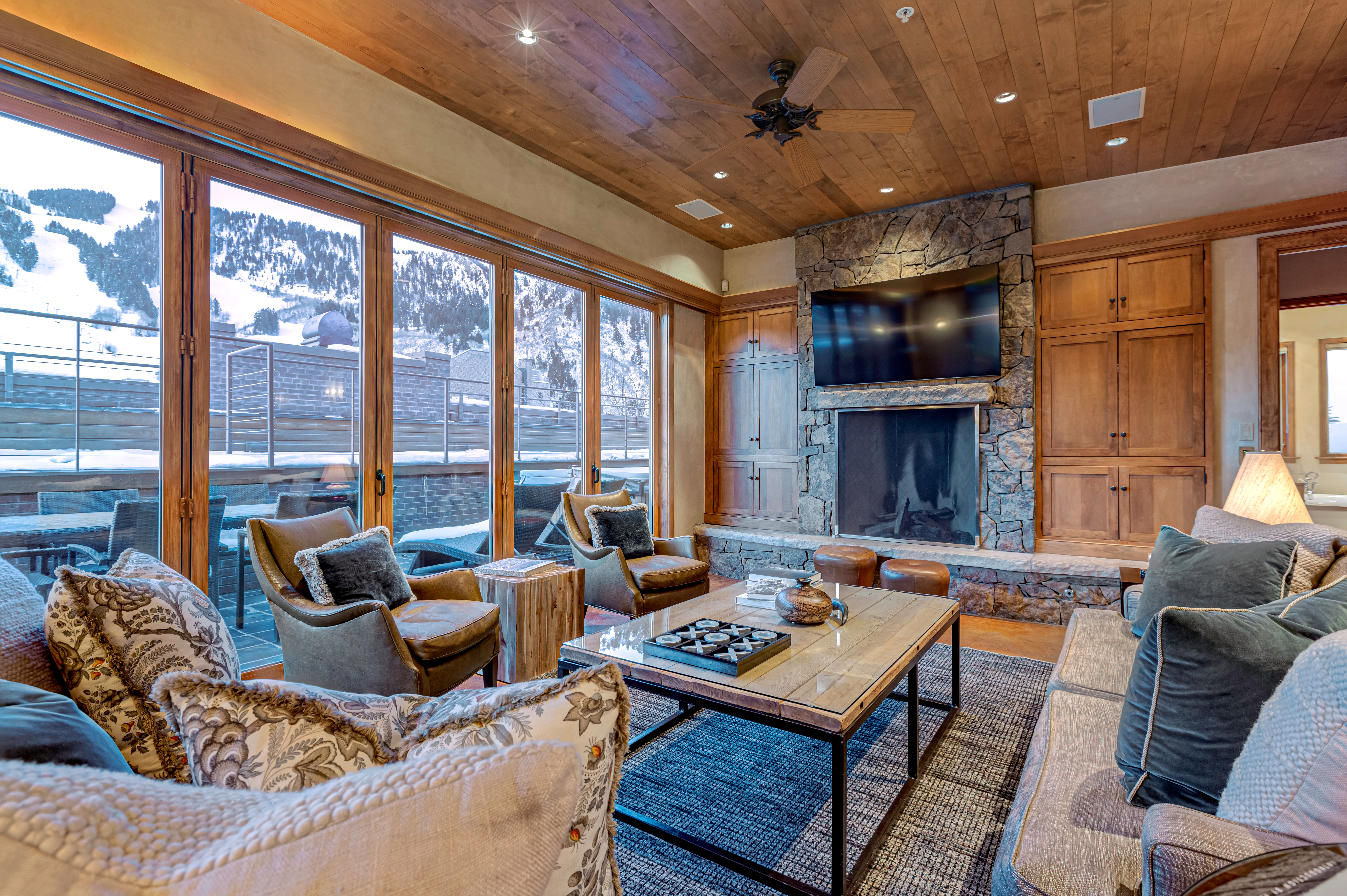 Living room with fireplace, views of Aspen Mountain. 