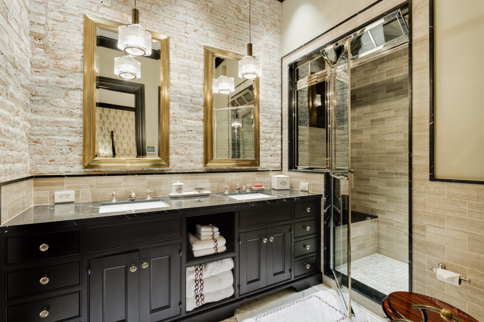 Bathroom with double vanity and a walk-in shower. 