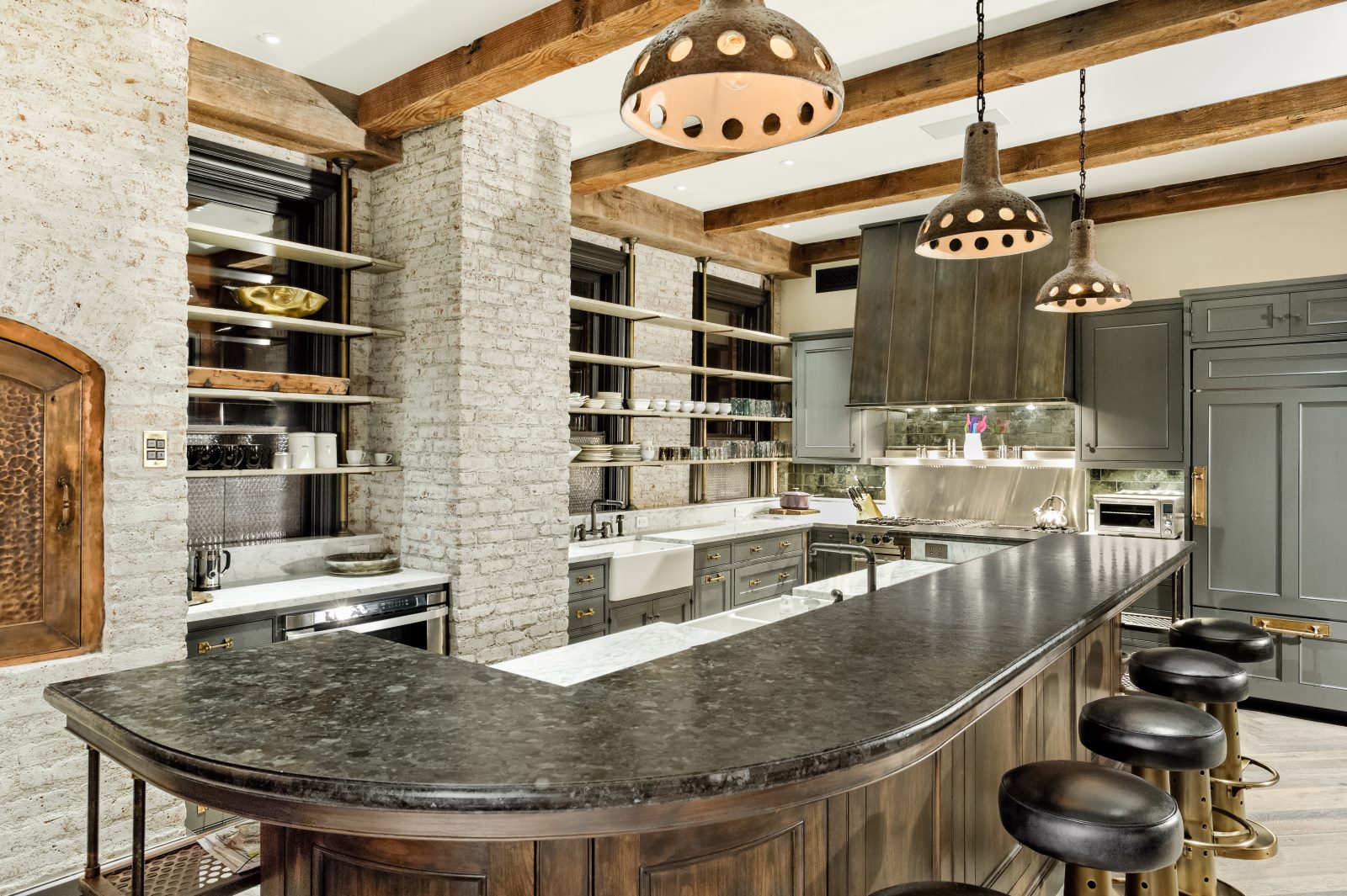 Kitchen with modern appliances and island seating. 