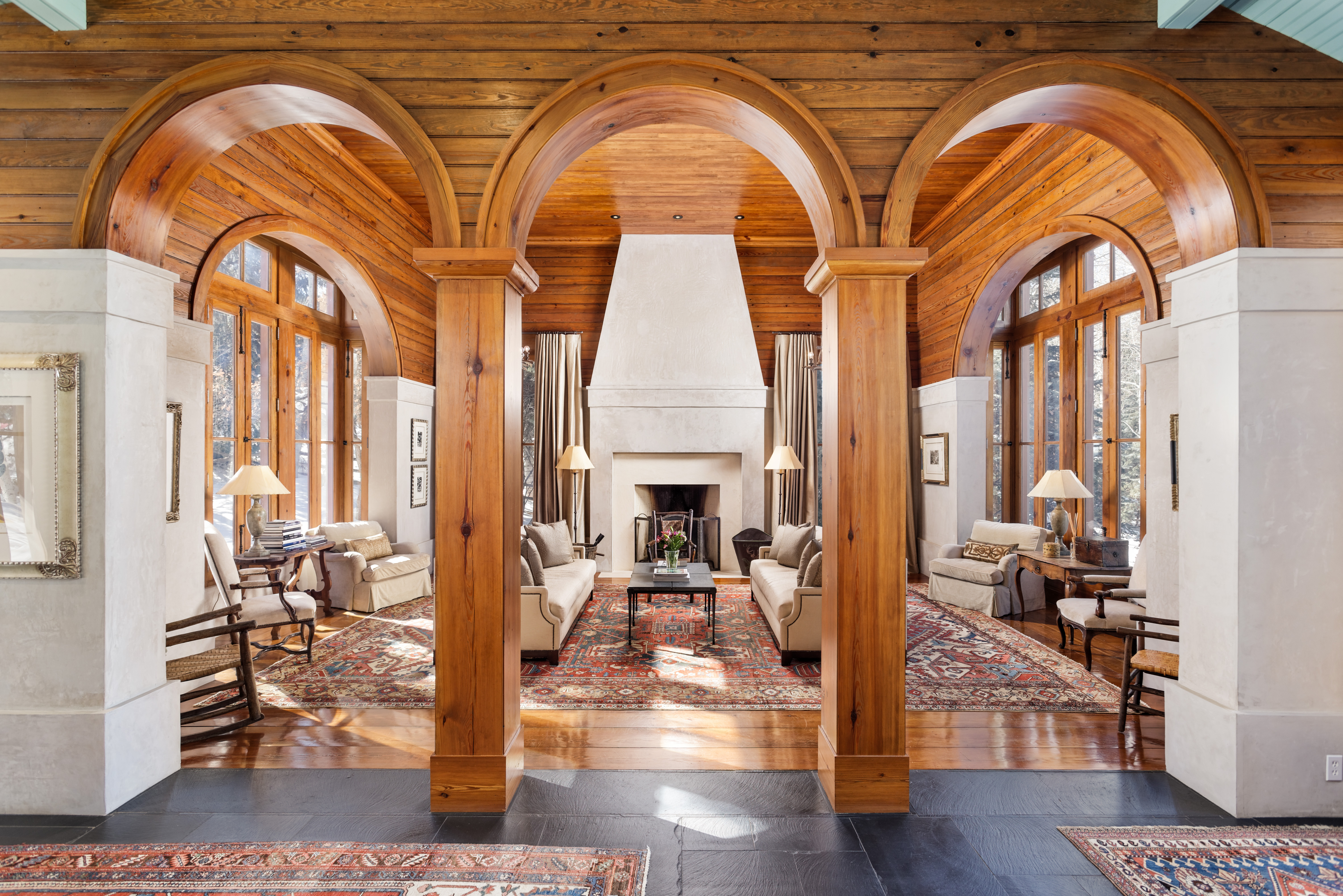 Stunning wooden arched entryway to living room. 