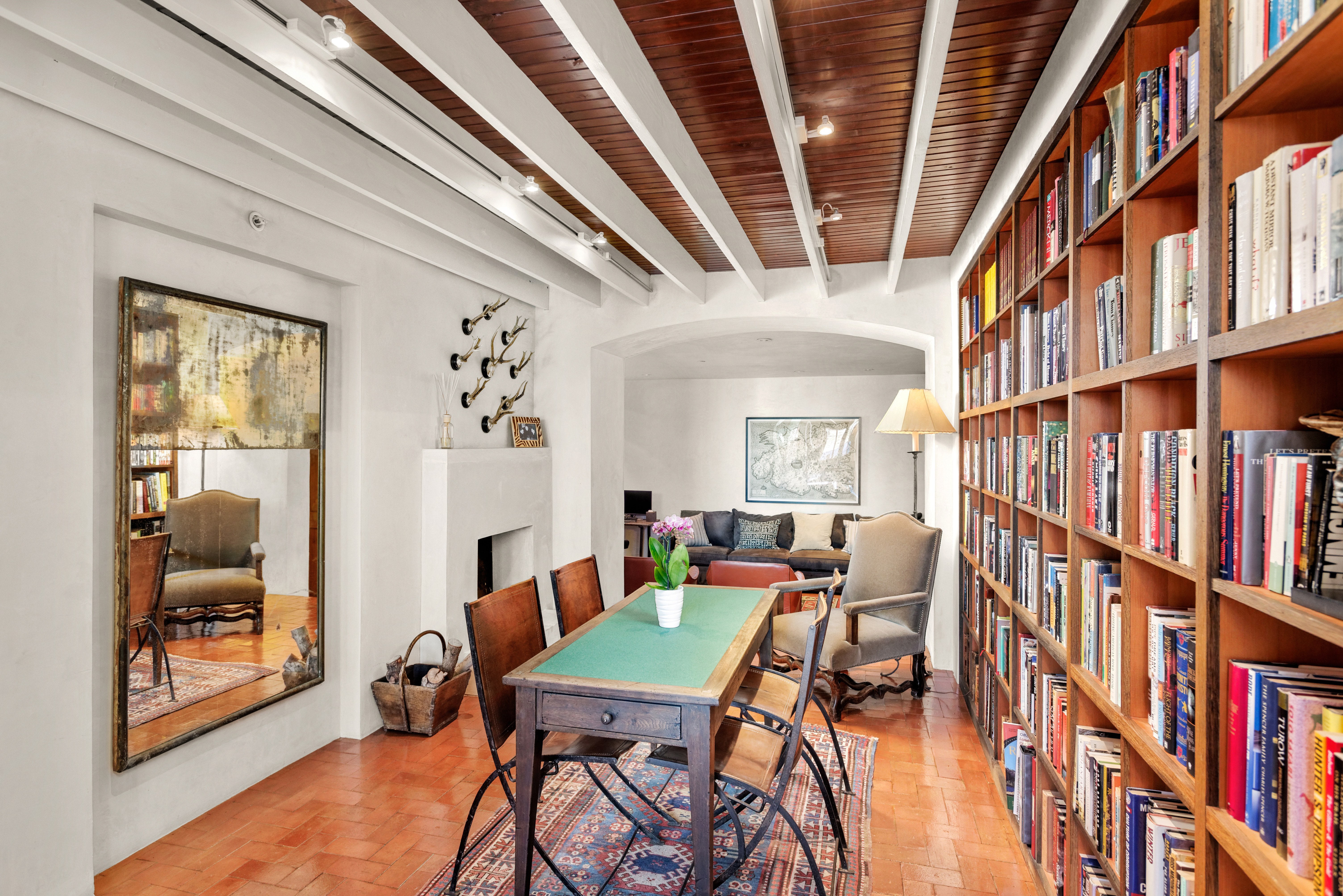 Library with seating and fireplace. 