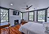 This bedroom has a king bed, tv, and desk.