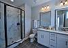 The first bathroom has a double sink vanity and walk-in shower.