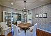 The dining room is set to seat four guests, but extra chairs can be found in the room.
