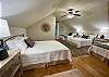 The loft room has 1 queen bed and 3 double beds.