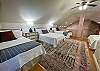 The third bedroom is located in the loft upstairs.