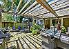 The back patio has plenty of seating for outdoor dining or sitting around the fire pit.