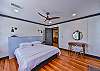 The third bedroom has a king bed and desk space along with a tv.