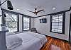 The first bedroom has a king bed and tv as well as an attached bathroom.